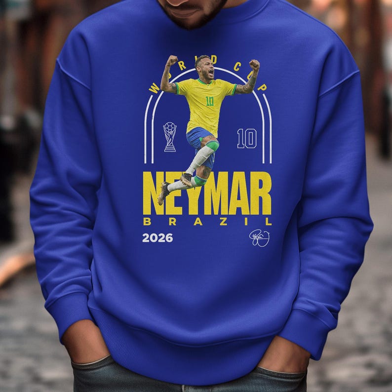 A man wearing a blue sweatshirt with a graphic of a soccer player and text related to the World Cup.