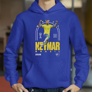 A blue hoodie with a graphic of a soccer player in yellow and blue, celebrating with his arms raised.