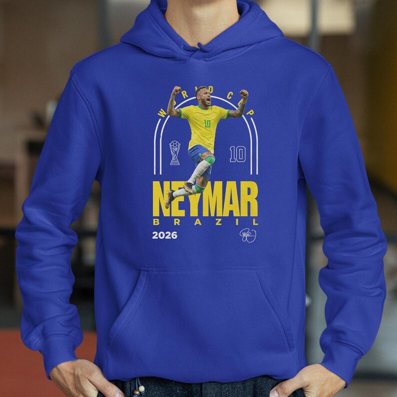 A blue hoodie with a graphic of a soccer player in yellow and blue, celebrating with his arms raised.