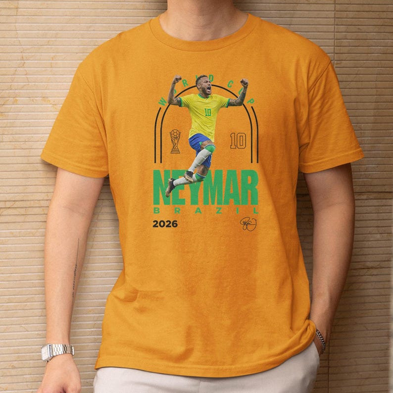 a person wearing a yellow t-shirt with a graphic of a soccer player and text related to the player's achievements.