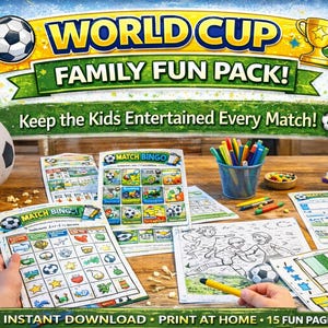 May include: A wooden table displays a soccer-themed family fun pack with the text "World Cup Family Fun Pack!" and "Keep the Kids Entertained Every Match!". The pack includes bingo cards, coloring pages, and a soccer ball.