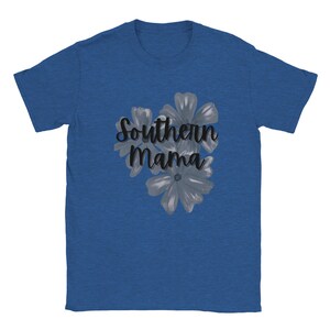 May include: A blue t-shirt featuring the text "Southern Mama" in a cursive font, accompanied by a floral design. The flowers are in shades of gray and white, creating a soft contrast against the shirt's background.