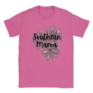 May include: A pink t-shirt featuring the text "Southern Mama" in a cursive font, with a floral design in gray. The shirt is made of a soft material and has short sleeves.