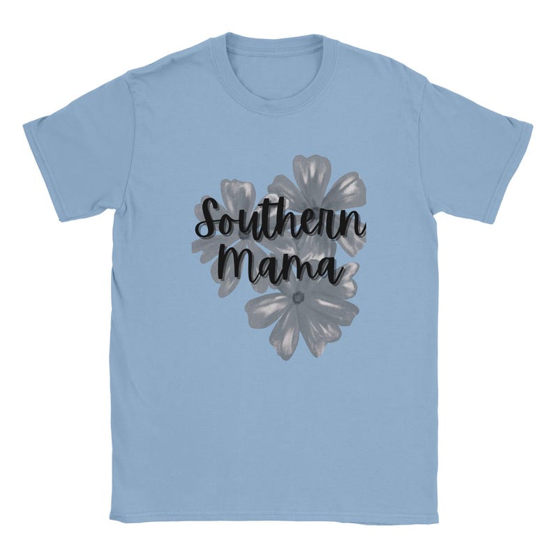May include: Light blue t-shirt with the text "Southern Mama" in a cursive font, accompanied by a floral design in shades of gray. The shirt is made of a soft material and has short sleeves.