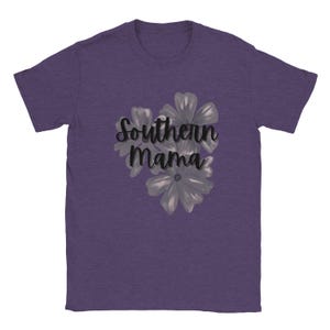 May include: Purple t-shirt with the text "Southern Mama" in a script font, accompanied by a floral design in shades of gray. The shirt is made of a soft material.