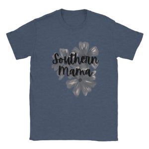 May include: A navy blue t-shirt featuring the text "Southern Mama" in a cursive font, with a floral design in shades of gray. The flowers are clustered below the text, creating a balanced design.