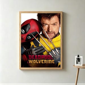 May include: A framed poster featuring Deadpool and Wolverine. Deadpool is wearing his red mask, and Wolverine is in a yellow and black suit, holding his claws. The poster has the words "Deadpool & Wolverine" at the bottom.