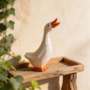 Hand carved wooden goose figurine in a white standing design