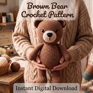 May include: A brown crocheted bear toy with a light beige muzzle and black eyes. The text Brown Bear Crochet Pattern and Instant Digital Download are visible. The bear has a textured yarn surface and is held in front of a cable knit sweater.