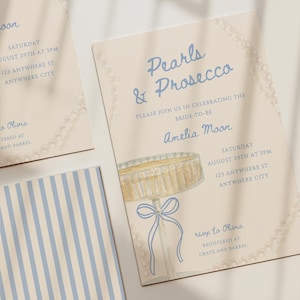 May include: A cream-colored invitation card featuring the text Pearls & Prosecco, a watercolor illustration of a champagne glass with a blue ribbon, and a pearl border. The card includes event details for Amelia Moon on August 29th at 3PM.