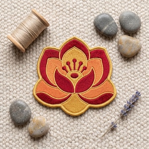 May include: A lotus flower embroidered patch featuring layered petals in shades of deep red, bright orange, and golden yellow. The design includes a central stamen detail with small circular tips, all outlined with a thick golden yellow border.