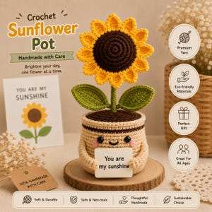 May include: A crochet sunflower in a beige pot with a smiling face, holding a white sign that reads "You are my sunshine." The sunflower has bright yellow petals, a dark brown center, and two green leaves on a stem, all crafted from yarn.