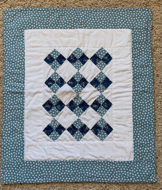 light blue and white quilt