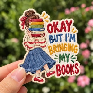 May include: An embroidered patch featuring a person with a brown hair bun holding a stack of colorful books. The text reads OKAY BUT I'M BRINGING MY BOOKS. The person wears a red and white striped shirt, a blue skirt, and red shoes.