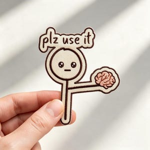 May include: An embroidered patch featuring a cream-colored magnifying glass character with a brown outline and a neutral facial expression. The text "plz use it" is embroidered in brown above the lens, and a pink brain is attached to the handle.