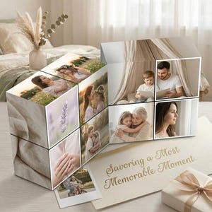 May include: A cube-shaped photo display with family photos. The images show a mother and daughter, a father reading to his son, and a grandmother hugging her granddaughter. A card reads "Savoring a Most Memorable Moment". The display is a sentimental gift.