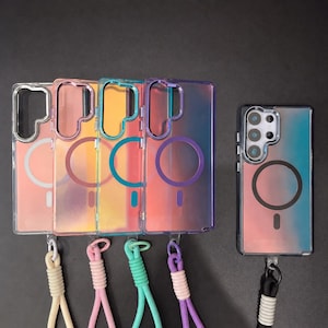May include: A collection of iridescent phone cases in various colors, including pink, yellow, teal, and purple. Each case has a circular design and a matching lanyard. The cases are displayed against a dark background.