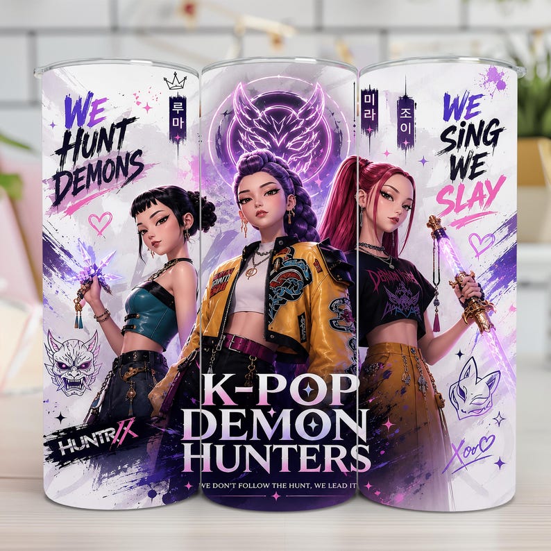 May include: A cylindrical tumbler featuring a graphic print of three anime-style characters with weapons. The design includes the text "WE HUNT DEMONS," "K-POP DEMON HUNTERS," and "WE SING WE SLAY" in purple and black, accented with hearts and masks.