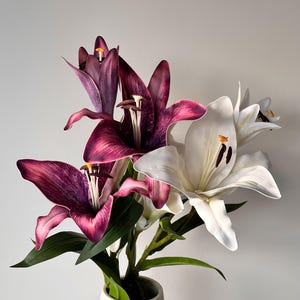 artificial lilies in purple and white colours
