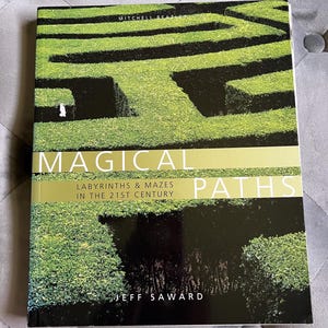 May include: A hardcover book titled "Magical Paths" featuring a green hedge maze on the cover. The book's title is in large white letters with a gold band. The author's name, Jeff Saward, is printed at the bottom.