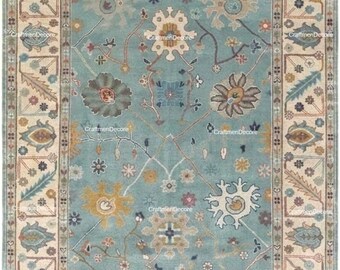 Alfombra de lana tejida a mano, estilo Oushak, color azul verdoso con motivos botánicos.