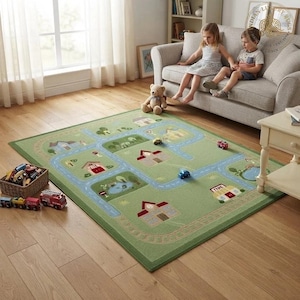 May include: A rectangular area rug featuring a green background with a printed town map design. The rug displays blue roads, various buildings, trees, and small ponds. A woven basket filled with toy cars and a red toy fire truck sit nearby.
