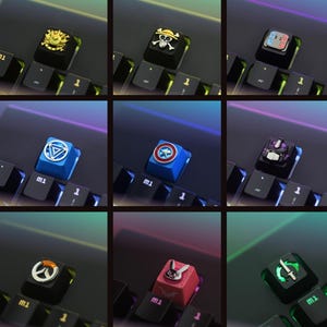 May include: A set of three ceramic mugs with a speckled, matte finish. The mugs are in shades of cream, light gray, and dark gray. Each mug has a simple, minimalist design and a rounded handle.