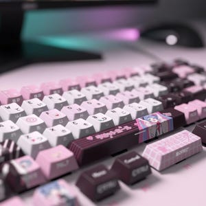 May include: A close-up of a mechanical keyboard with a pink and white color scheme. The keyboard has custom keycaps with Japanese characters and anime-style artwork. The keys are arranged in a standard QWERTY layout.