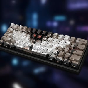 May include: A mechanical keyboard with a black base and white, gray, and black keycaps. The keycaps feature Japanese characters and a graphic design. The keyboard has a compact layout and is designed for gaming or typing.