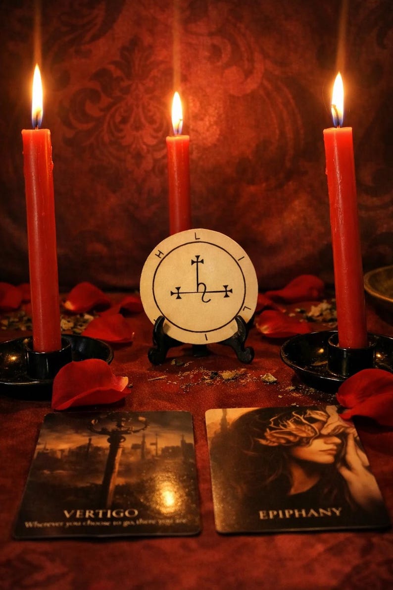 May include: A mystical scene featuring three red candles with lit flames, a circular emblem, and two tarot cards. The cards read "VERTIGO" and "EPIPHANY". Scattered rose petals add to the ambiance. The candles are in black holders.