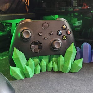 May include: A white ceramic mug with a black handle and the text "But first, coffee" in a handwritten style. The mug is on a white surface. The mug is 10 cm tall.