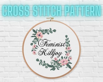 May include: Cross stitch pattern with a floral wreath and the text "Feminist Killjoy".