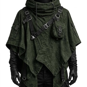 May include: A dark olive green hooded poncho featuring a layered asymmetrical hem, black adjustable webbing straps, metal buckles, and multiple utility pockets on the chest and sleeves. The garment is worn over black long gloves and black pants.