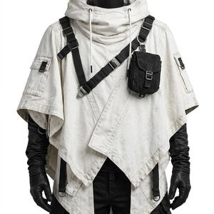 May include: An off-white hooded poncho featuring a black tactical harness system with adjustable straps and a small black utility pouch attached to the chest. The garment includes side pockets and is worn over black long-sleeved gloves and black pants.