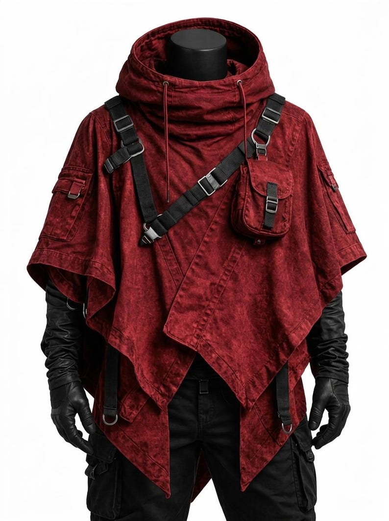 May include: A dark red hooded poncho featuring a distressed fabric texture, black adjustable nylon straps with metal buckles, and a small utility pocket on the chest. The garment includes side pockets and a high collar with drawstring cords.