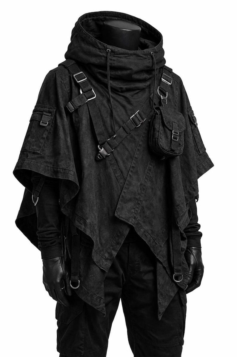 May include: A black hooded poncho featuring multiple utility pockets, adjustable straps with metal buckles, and a layered asymmetrical hem. The garment includes a detachable small pouch on the chest, side cargo pockets, and integrated D-ring hardware.