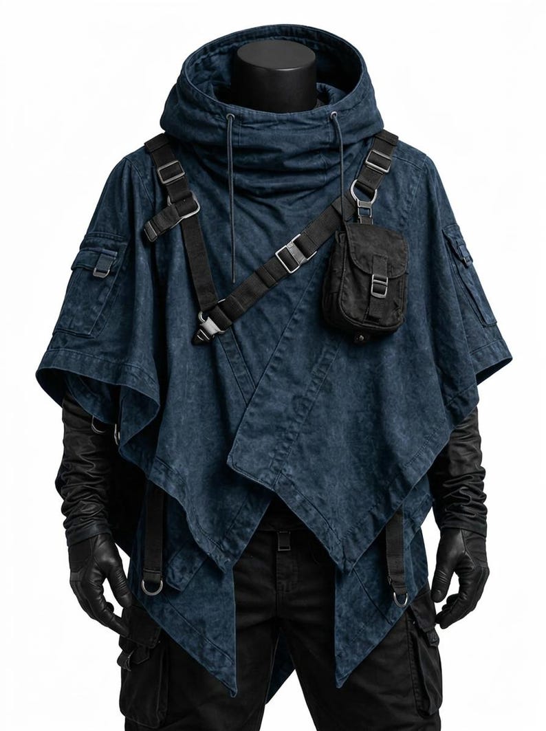 May include: A dark blue hooded poncho featuring a distressed fabric texture, an asymmetrical hem, and black tactical straps with metal buckles. A small black pouch is attached to the chest strap, and the garment includes side pockets.