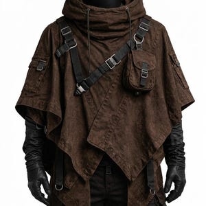 May include: A dark brown hooded poncho featuring black adjustable straps, metal buckles, and a small attached pouch on the chest. The garment has a layered, asymmetrical hemline and is worn over black long-sleeved gloves and dark trousers.