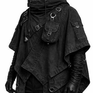 May include: A black hooded poncho featuring an asymmetrical hem, multiple utility pockets with metal buckles, and adjustable straps across the chest. The garment includes a high collar with drawstring cords and long sleeves with textured detailing.