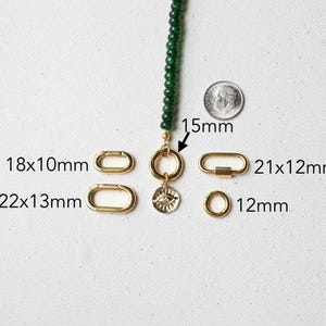 May include: A close-up of various gold-colored jewelry findings, including clasps and rings, next to a green beaded strand. Measurements are provided in millimeters: 18x10mm, 22x13mm, 21x12mm, and 12mm. A dime is included for size reference.