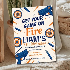 May include: A party invitation with a cream background, featuring blue and orange graphics of toy guns, targets, and darts. The text reads "GET YOUR GAME ON Fire LIAM'S 7th Birthday" with event details.