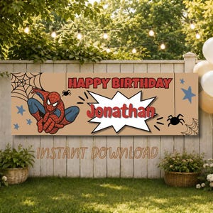 May include: A rectangular birthday banner with a tan background featuring a red and blue superhero character, black spiderwebs, spiders, and blue stars. The text reads HAPPY BIRTHDAY in red and the name Jonathan in red inside a white comic burst.