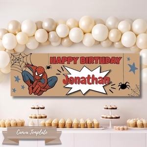 May include: A rectangular birthday banner with a tan background featuring a red and blue Spider-Man character, black spider webs, and blue stars. The text reads HAPPY BIRTHDAY in red and Jonathan in red inside a white comic-style speech bubble.