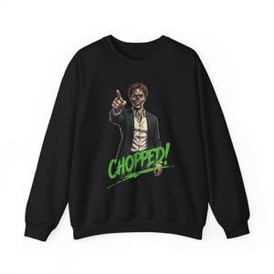 May include: Black sweatshirt with a graphic of a man pointing, and the word "CHOPPED!" in green. The man is wearing a suit jacket over a white shirt. The design has a comic book style.
