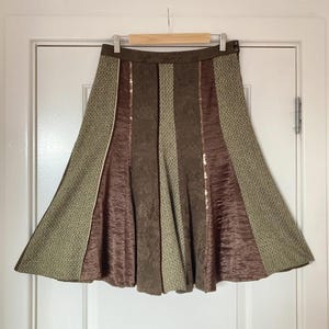 May include: A set of three ceramic nesting bowls in shades of blue, green, and white. The bowls feature a speckled glaze and a simple, modern design. The largest bowl measures approximately 6 inches in diameter.