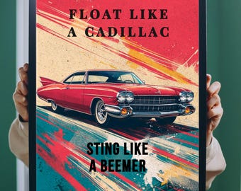 May include: Framed print with a red classic Cadillac car and the text "FLOAT LIKE A CADILLAC" and "STING LIKE A BEEMER". The background has a retro design with red, yellow, and blue colours. The car is a vintage model.