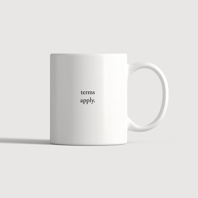 May include: A white ceramic mug featuring the black text "terms apply." printed in a simple serif font on the front. The mug has a smooth, cylindrical body and a curved handle on the right side, maintaining a clean and minimalist appearance.