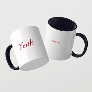 May include: Two white ceramic mugs with black handles and black interiors. One mug features the red text "Yeah" in a stylized font, while the other mug displays the red text "but no." in a smaller, simple font on the exterior surface.