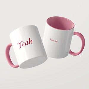 May include: Two white ceramic mugs with pink interiors and pink handles. One mug features the red text "Yeah" on the front, while the other mug displays the red text "but no." on the front. Both mugs have a smooth, glossy finish and a cylindrical shape.