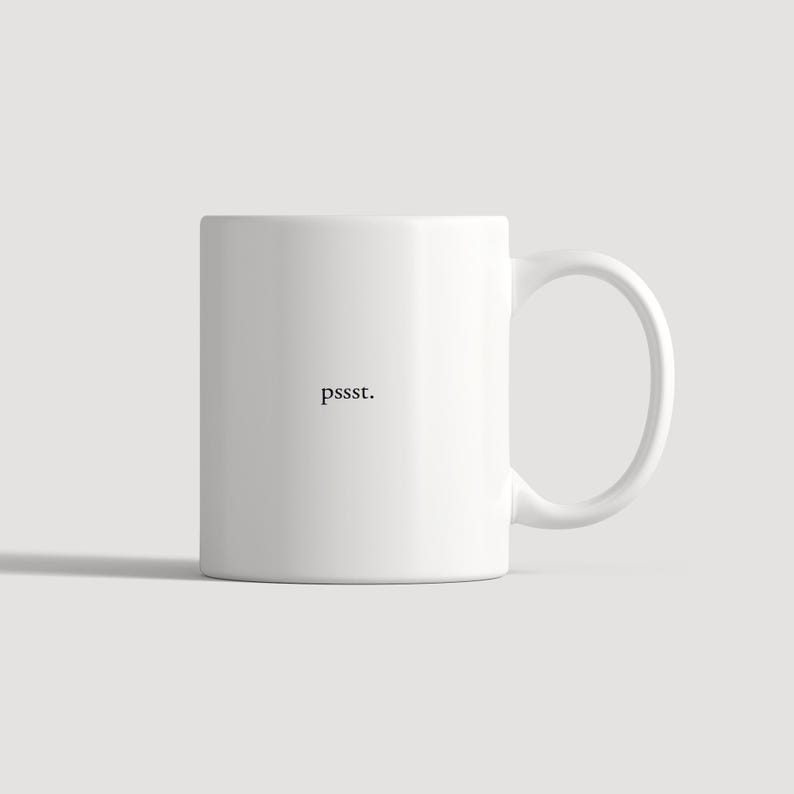 May include: A white ceramic mug featuring a smooth, cylindrical body and a curved handle on the right side. The word pssst. is printed in a small, black, serif font in the centre of the mug, creating a simple and clean visual appearance.